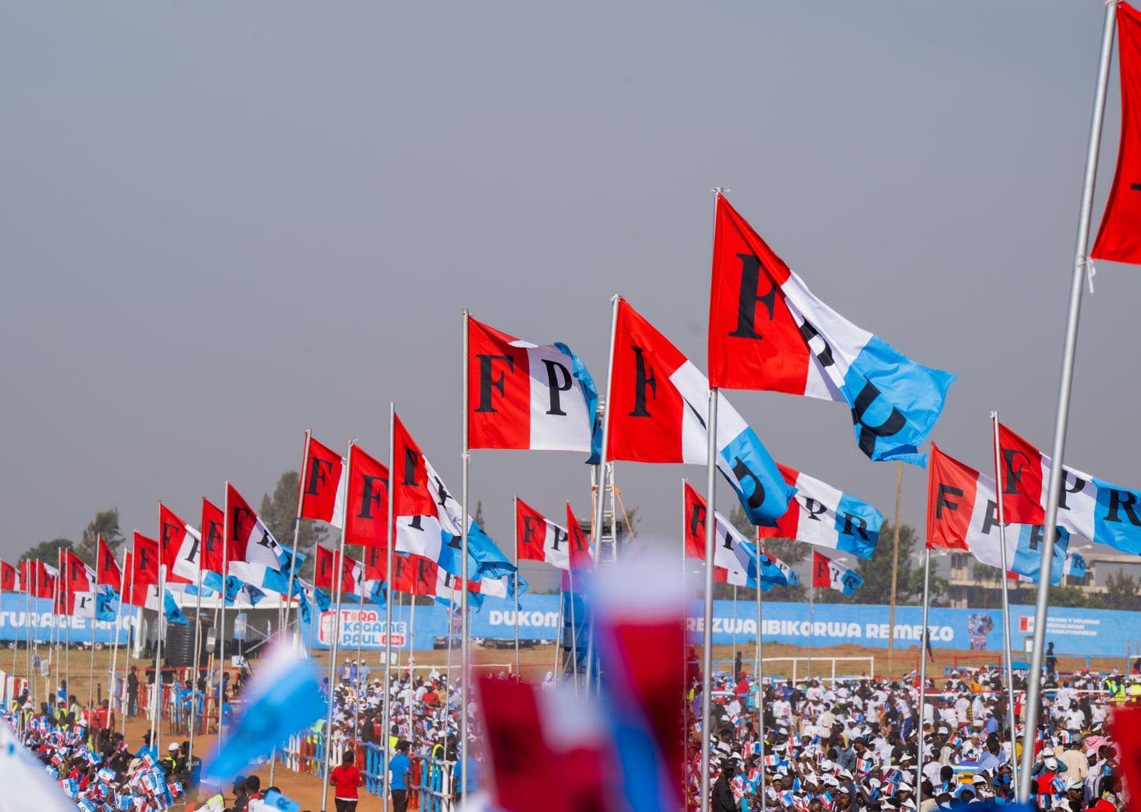 Flags flying over a large gathering of participants